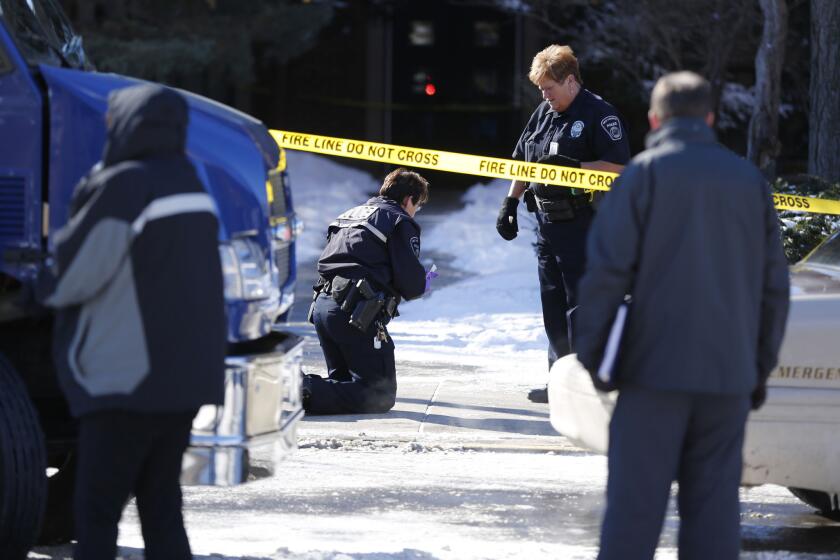 West Lafayette police gather evidence after a shooting about noon Tuesday in the electrical engineering building at Purdue University in West Lafayette, Ind. One person was killed in a classroom, and a suspect surrendered to police within minutes of the attack, officials said.