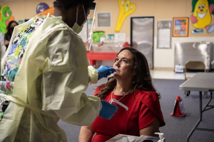SAN DIEGO, CA - JANUARY 12: San Diego Unified Superintendent Cindy Marten is administered a COVID test by CNA / Nurse Assistant Malaysia Major as part of a new district program at Penn Elementary on Tuesday, Jan. 12, 2021 in San Diego, CA. (Jarrod Valliere / The San Diego Union-Tribune)