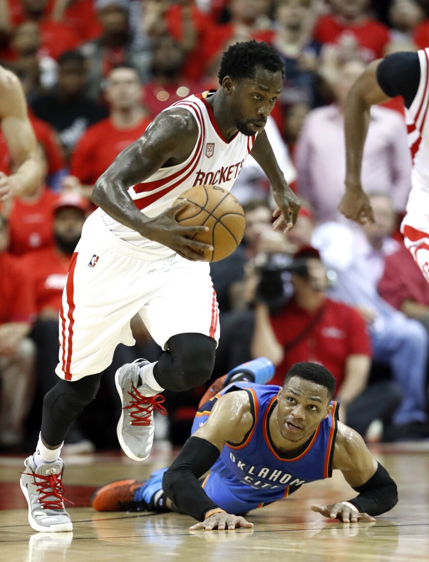 Patrick Beverley races away with the ball after stealing it from Russell Westbrook, who is down