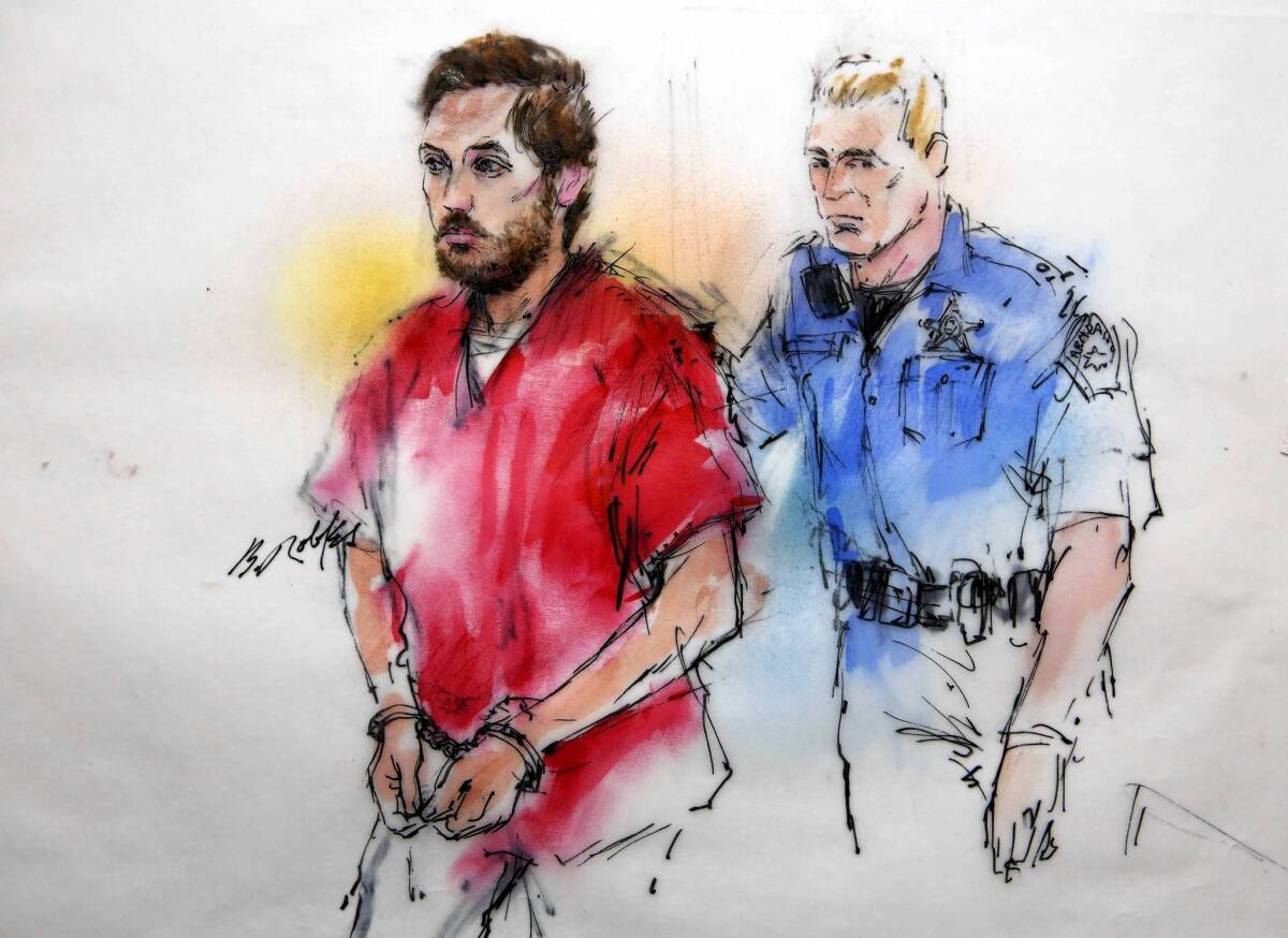 James E. Holmes is shown in a courtroom sketch being escorted to his preliminary hearing in Centennial, Colo.