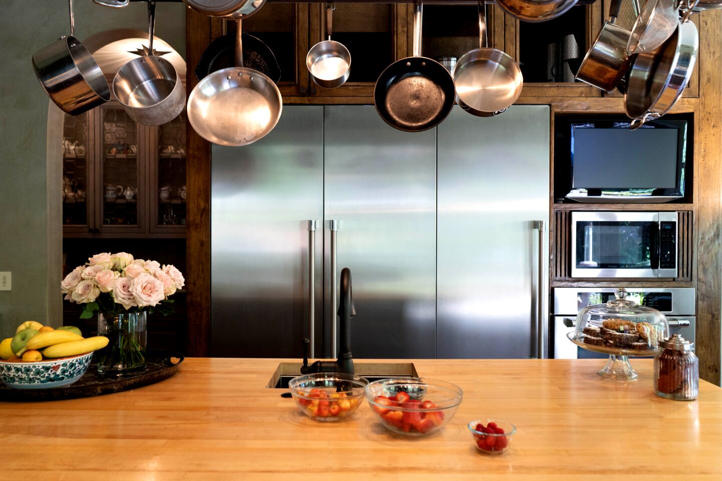 The heart of the home is the spacious kitchen, where Elliott indulges in his favorite pastime when not working.