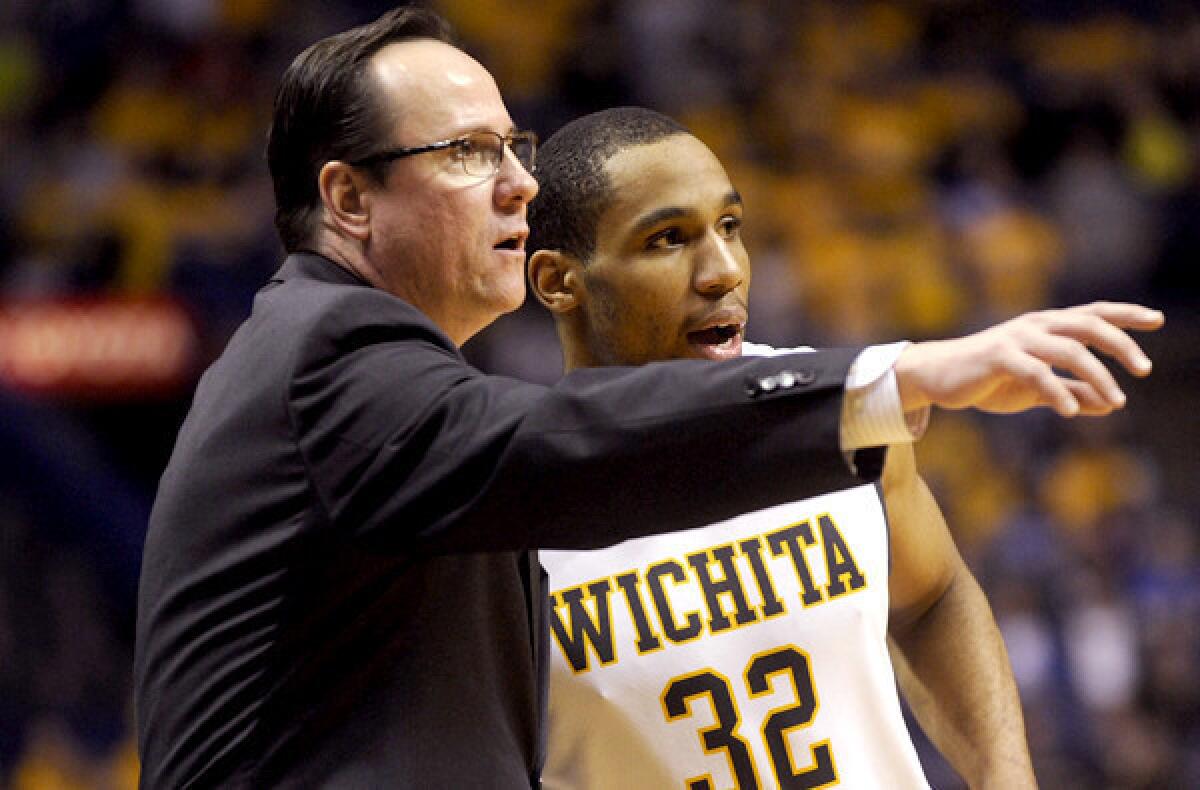 Wichita State Coach Gregg Marshall discusses strategy with Tekele Cotton against Indiana State in the Missouri Valley Conference tournament championship game.