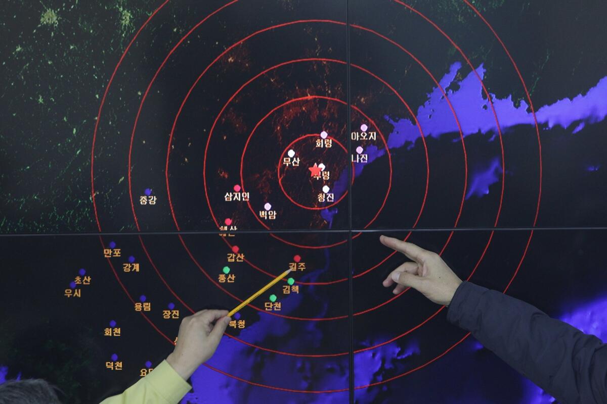 Ko Yun-hwa, left, Korea Meteorological Administration administrator, and Yun Won-Tae, director general of the administration, checks a screen that shows seismic waves from North Korea on Jan. 6, 2016, in Seoul, South Korea.