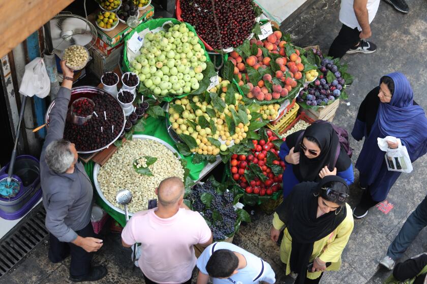 Customers buy fresh fruits at a market in the Iranian capital Tehran on July 3, 2019. - The Iranian economy is struggling in part because of the crippling US sanctions targeting Iran's oil sales, banking transactions and major industries like steel and petrochemicals. (Photo by ATTA KENARE / AFP) (Photo credit should read ATTA KENARE/AFP/Getty Images)