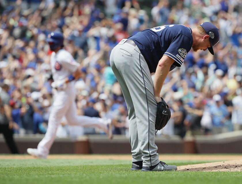 Padres pitcher Eric Lauer reacts after giving up a grand slam to the Cubs' Anthony Rizzo in the third inning of Friday's game at Wrigley Field.