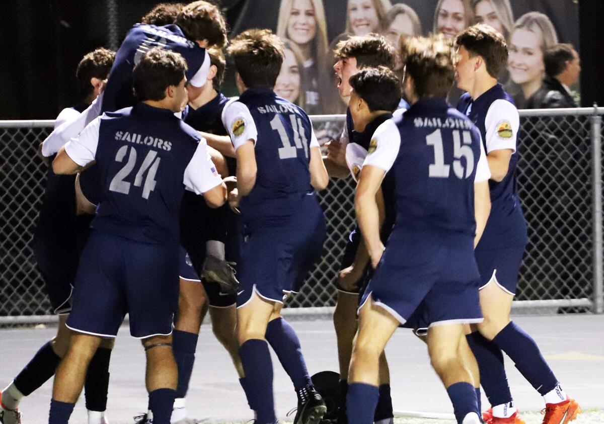 The Newport Harbor boys' soccer team celebrates after a goal from Olivier Renard against Corona del Mar on Wednesday.