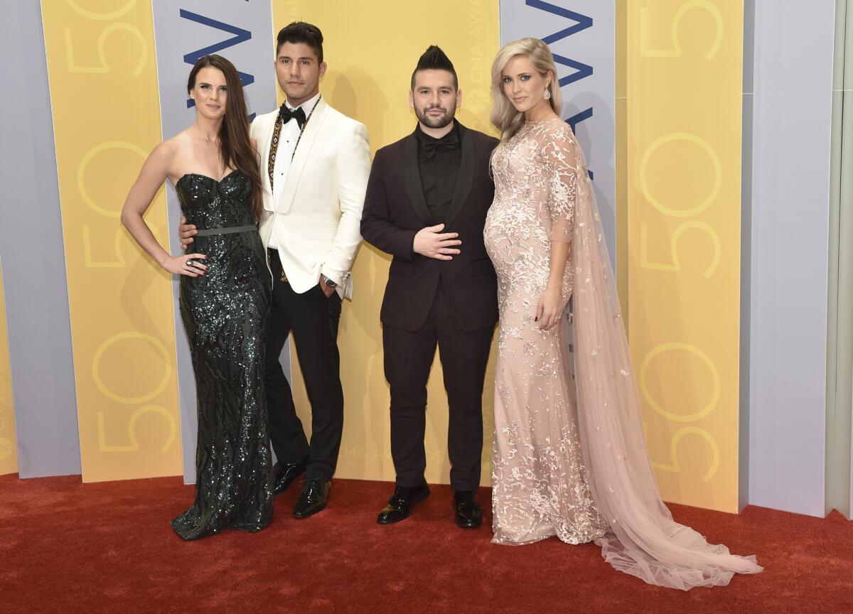 Abby Law, left, Dan Smyers and Shay Mooney of the musical group Dan + Shay, and Hannah Billingsley arrive at the 50th CMA Award