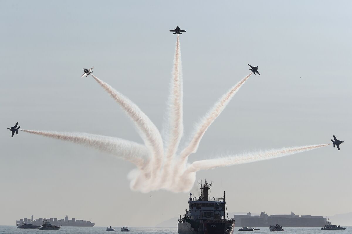The U.S. Navy Blue Angels team members split out as they perform on the first day of the Pacific Airshow.