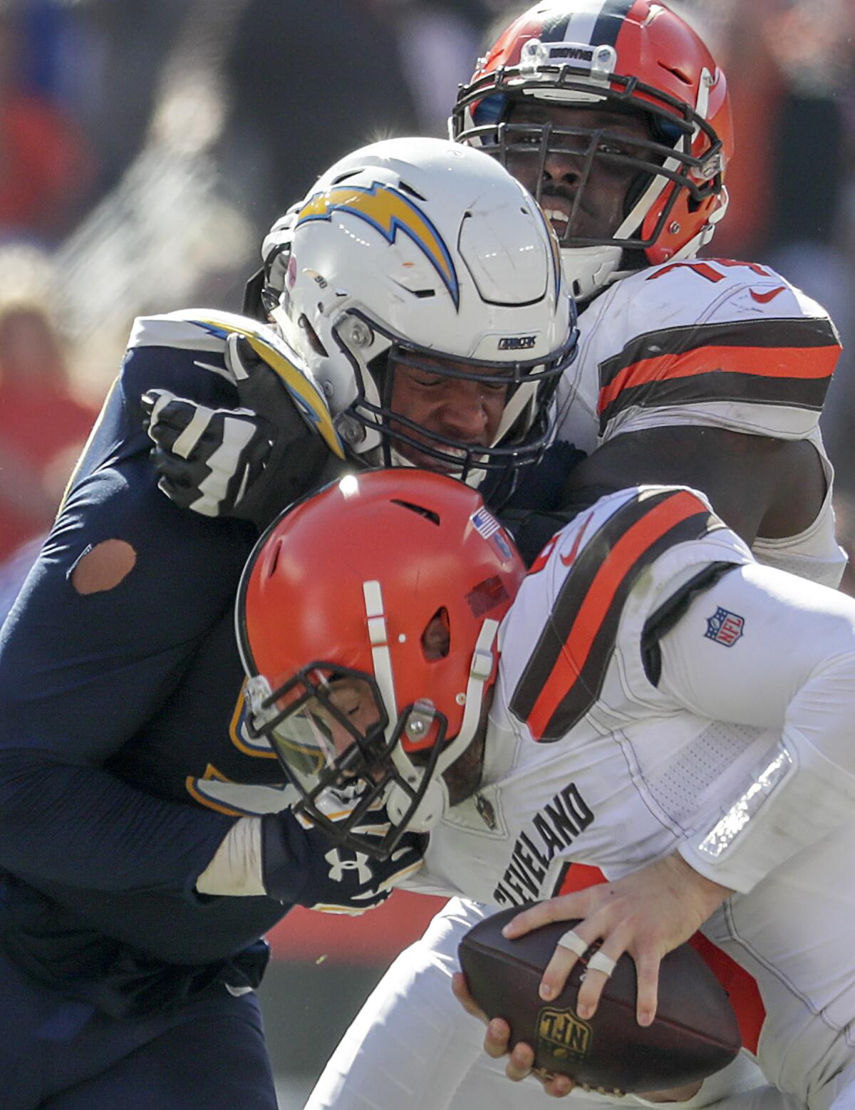 Chagers defensive lineaman Isaac Rochell sacks Cleveland Browns quarterback Baker Mayfield during second quarter action at Firstenergy Stadium on Sunday.