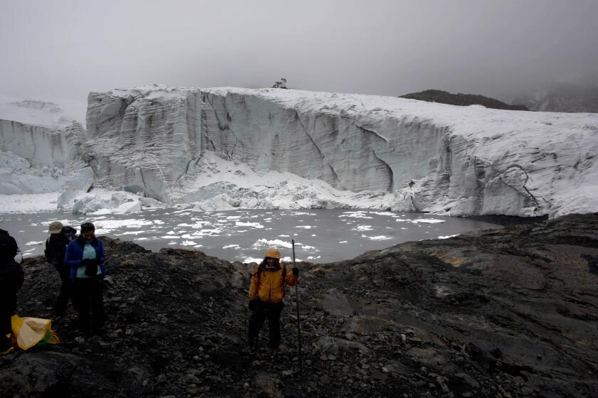 A new study suggests sea level rise, in part from melting land glaciers, has been overestimated for much of the 20th century. Here, scientists at the Pastoruri glacier in Huaraz, Peru, measure ice thickness.