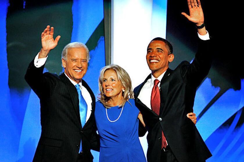 Sen. Barack Obama of Illinois, right, makes a surprise appearance onstage at the Democratic National Convention after Sen. Joe Biden of Delaware, seen with his wife, Jill, gives his acceptance speech as the Democratic Party's nominee for vice president. Earlier in the day, Obama officially became the first black presidential nominee of a major party.