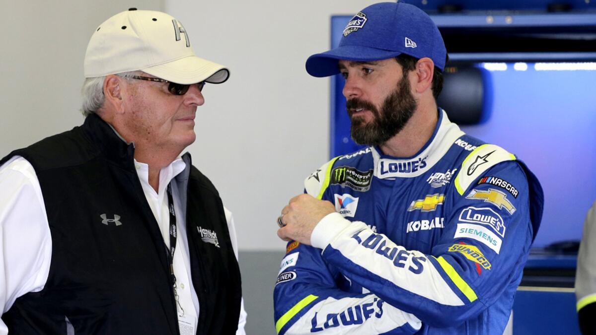 NASCAR driver Jimmie Johnson talks to team owner Rick Hendrick in their garage during a practice session at Daytona International Speedway on Friday.