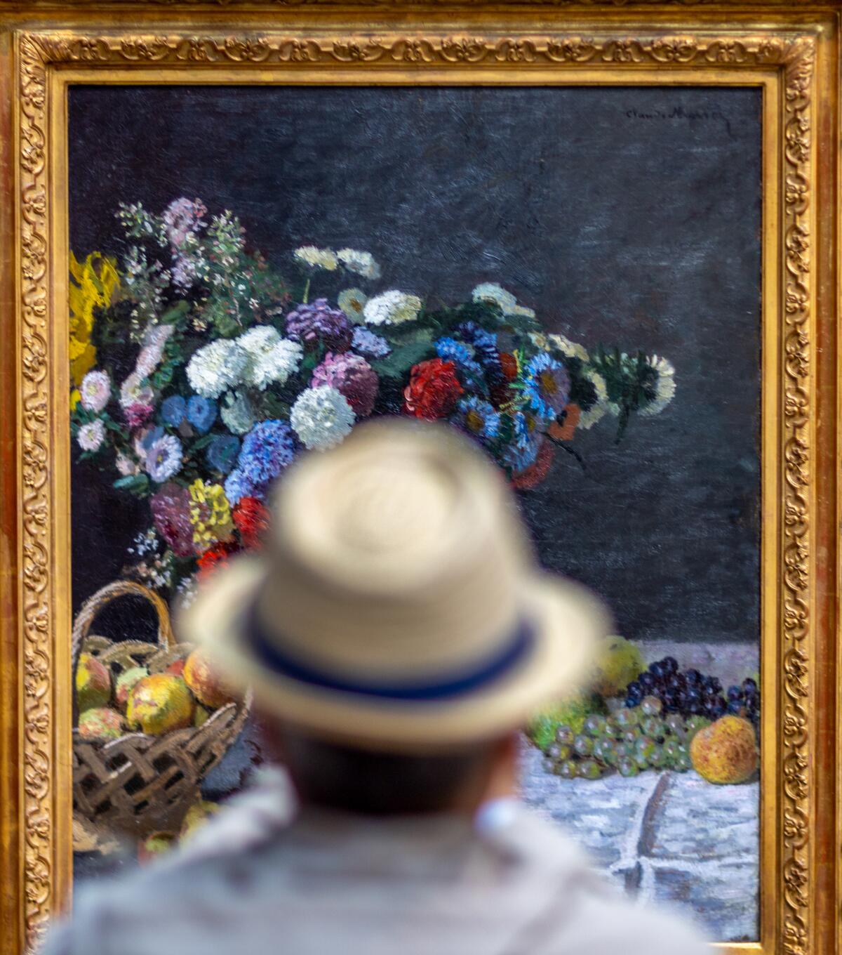 A Getty visitor views Monet's "Still Life With Flowers and Fruit" in the West Pavilion.