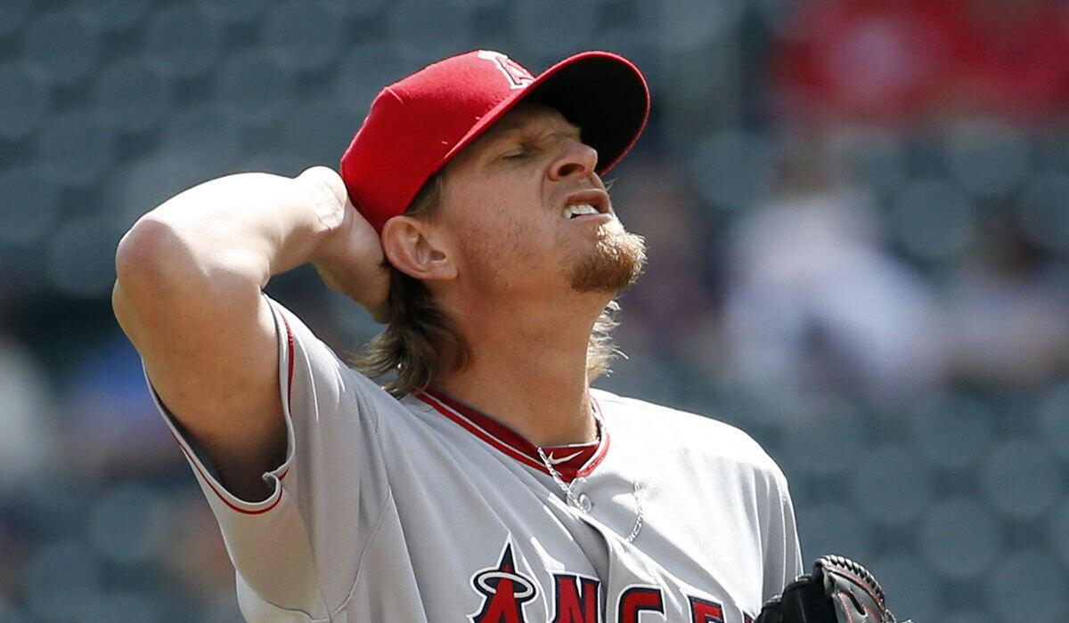 Angels pitcher Jered Weaver reacts after giving up a single to Minnesota designated hitter Joe Mauer on Saturday.