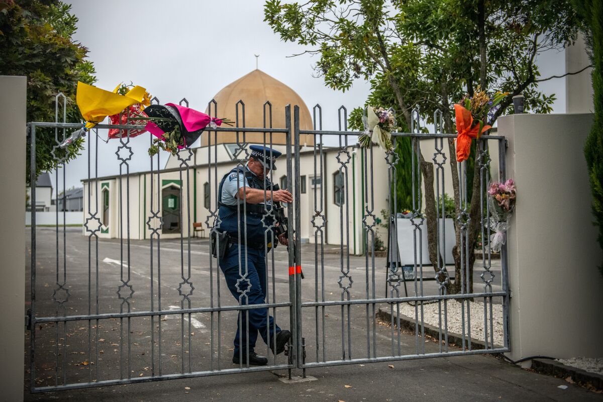  An armed police officer closes a gate to Al Noor Mosque after it was reopened in Christchurch, New Zealand, in 2019.