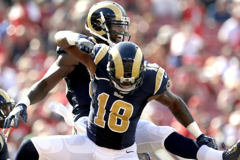 Rams receiver Brian Quick celebrates with teammate Kenny Britt (18) after scoring on a 44-yard pass play Sunday.