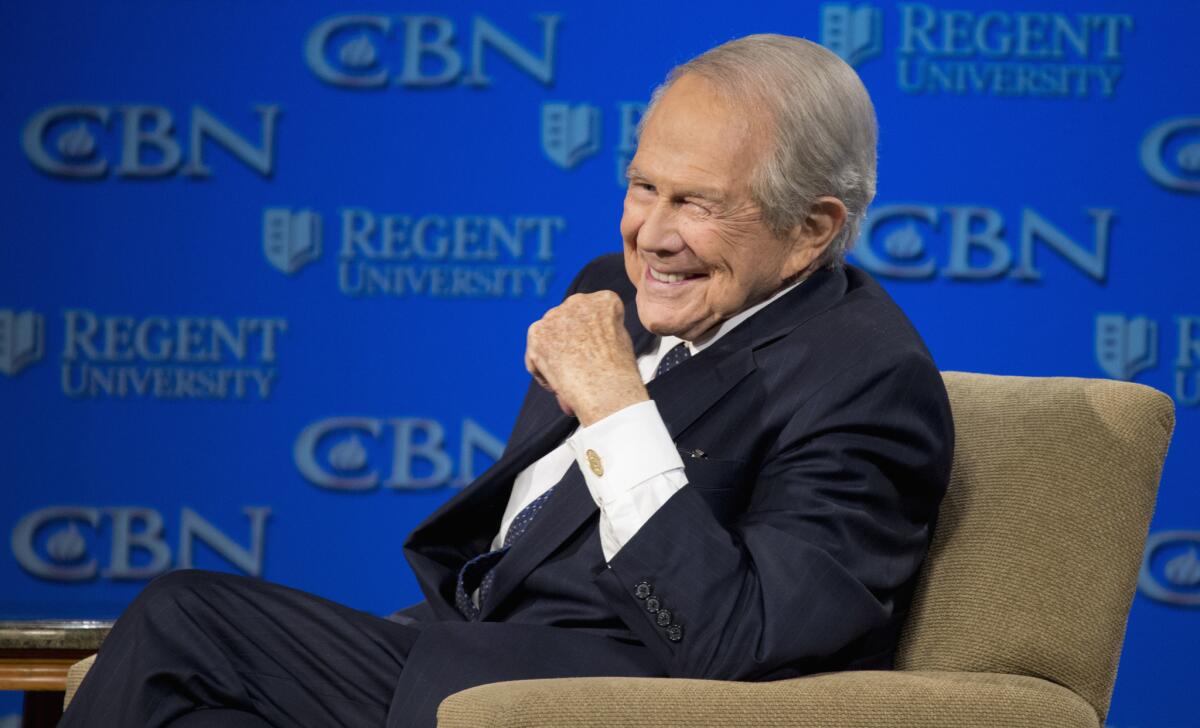 The Rev. Pat Robertson listens as Republican presidential candidate Donald Trump speaks at Regent University in Virginia Beach, Va., on Wednesday, Feb. 24, 2016.