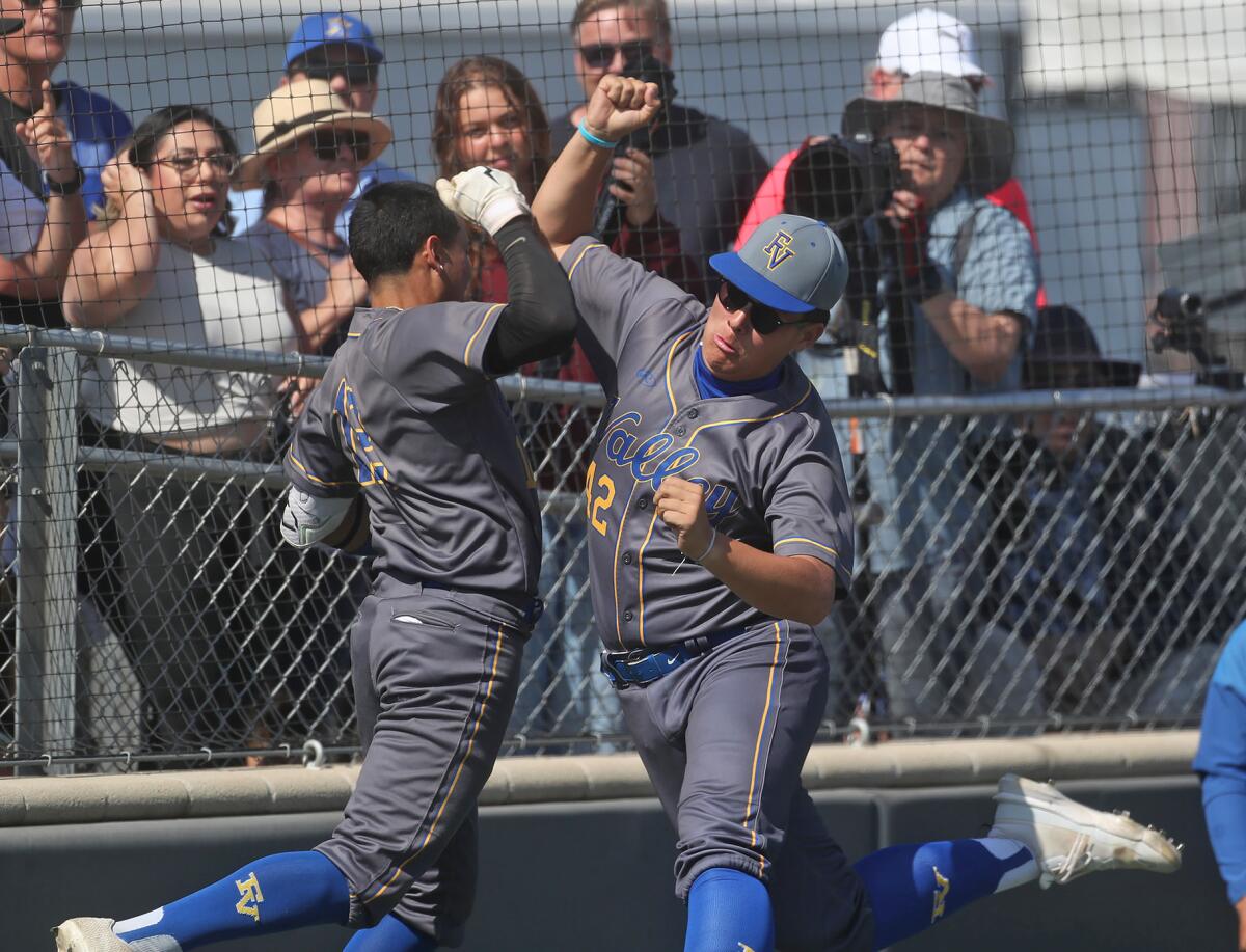 Fountain Valley's Anthony Zamora, left, celebrates with a teammate after hitting a solo home run Tuesday.