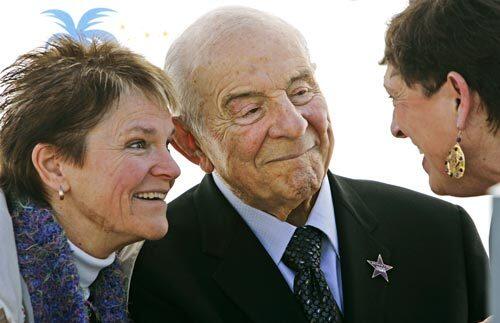 On his 90th birthday in January 2007, Carl Karcher, founder of the Carl's Jr. restaurants, receives a star on the Anaheim/Orange County Walk of Stars. His niece Mary Harrigan is at left. At right is Sue O'Donnell, who worked at one of his original restaurants.