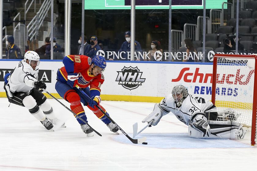 St. Louis Blues' Brayden Schenn (10) is unable to score as Los Angeles Kings' goaltender Jonathan Quick (32) and Anze Kopitar (11), of Slovenia, defend during the second period of an NHL hockey game Monday, Feb. 22, 2021, in St. Louis. (AP Photo/Scott Kane)
