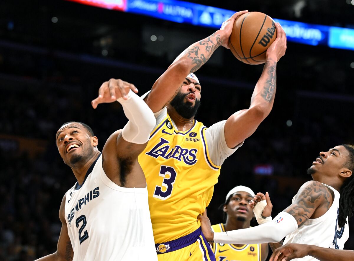 Lakers forward Anthony Davis grabs a rebound from Grizzlies forward Xavier Tillman.