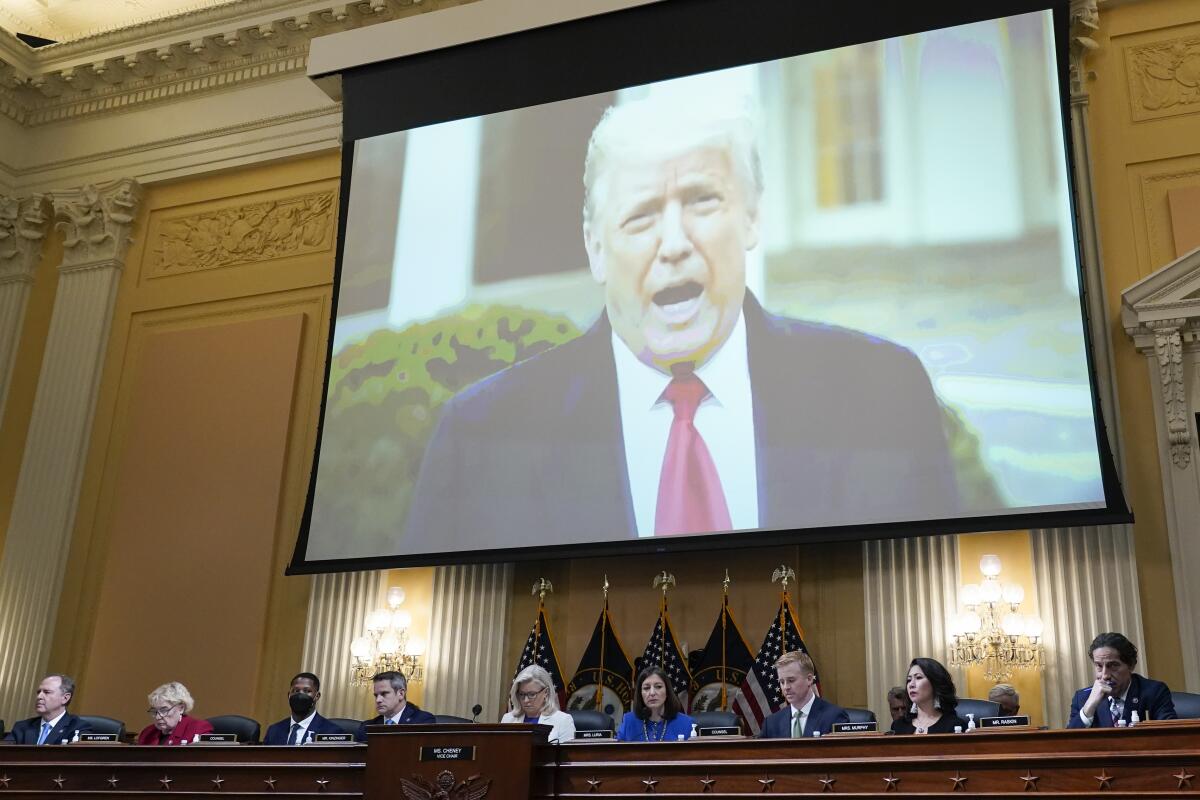 A video of former President Trump is shown on a screen, as House members hold a hearing at the Capitol.