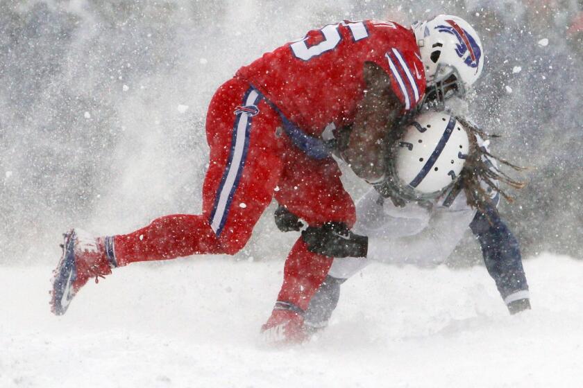 Buffalo Bills fullback Mike Tolbert, left, tries to run through Indianapolis Colts strong safety Matthias Farley during the second half of an NFL football game, Sunday, Dec. 10, 2017, in Orchard Park, N.Y. (AP Photo/Jeffrey T. Barnes)