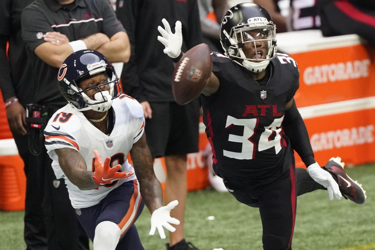 Atlanta Falcons defensive back Darqueze Dennard (34) misses the catch against Chicago Bears wide receiver Ted Ginn (19) during the first half of an NFL football game, Sunday, Sept. 27, 2020, in Atlanta. (AP Photo/John Bazemore)