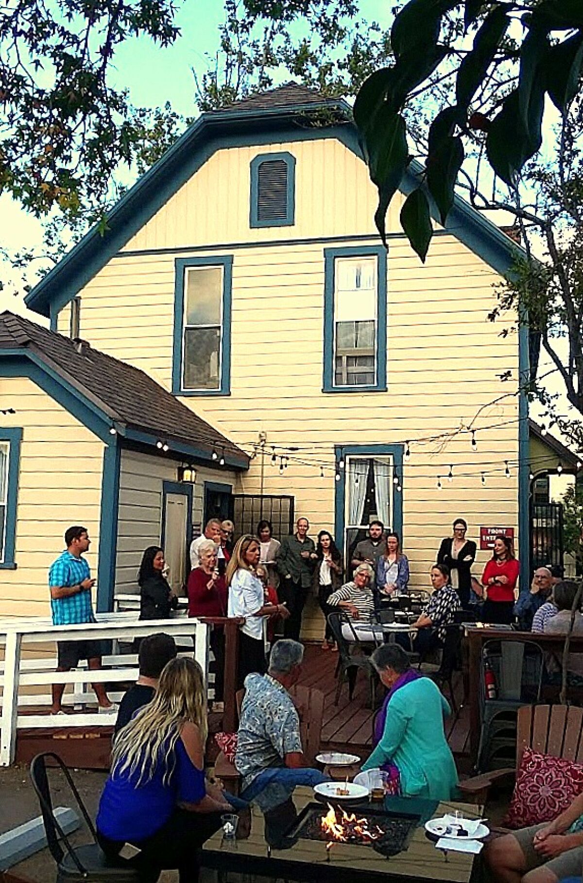 Cathy Gallagher (in white sweater) discusses the history of the Jennings House on the back porch of her Jennings House Cafe.