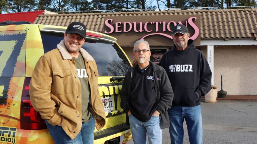 Morning radio show hosts David Bazzel, from left, Roger Scott and Tommy Smith pose for a photo outside a lingerie shop in Little Rock, Ark., where they hosted their show for KABZ-FM on Friday.