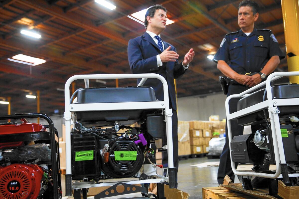 U.S. EPA Regional Administrator Jared Blumenfeld, left, at a Carson news conference announcing that federal environmental and customs officials found hundreds of imported vehicles, engines and other equipment that failed to comply with U.S. emissions standards.