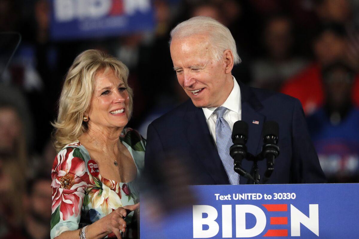 FILE - In this Feb. 29, 2020 file photo, Democratic presidential candidate former Vice President Joe Biden, accompanied by his wife Jill Biden, speaks at a primary night election rally in Columbia, S.C. Jill Biden is a prankster. The wife of presumptive Democratic presidential nominee Joe Biden once sneaked into a close aide’s birthday party dressed as catering staff and surprised him with a drink.(AP Photo/Gerald Herbert)