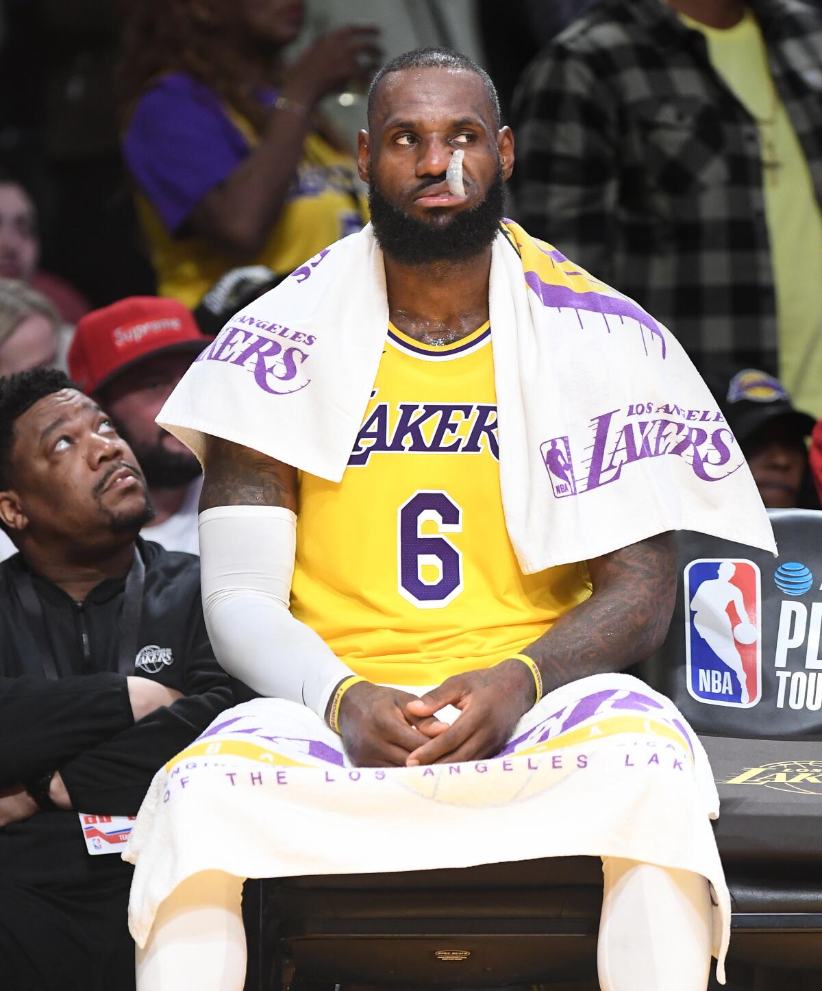 LeBron James sits on the bench during the Lakers' play-in game against the Timberwolves at Crypto.com Arena Tuesday.