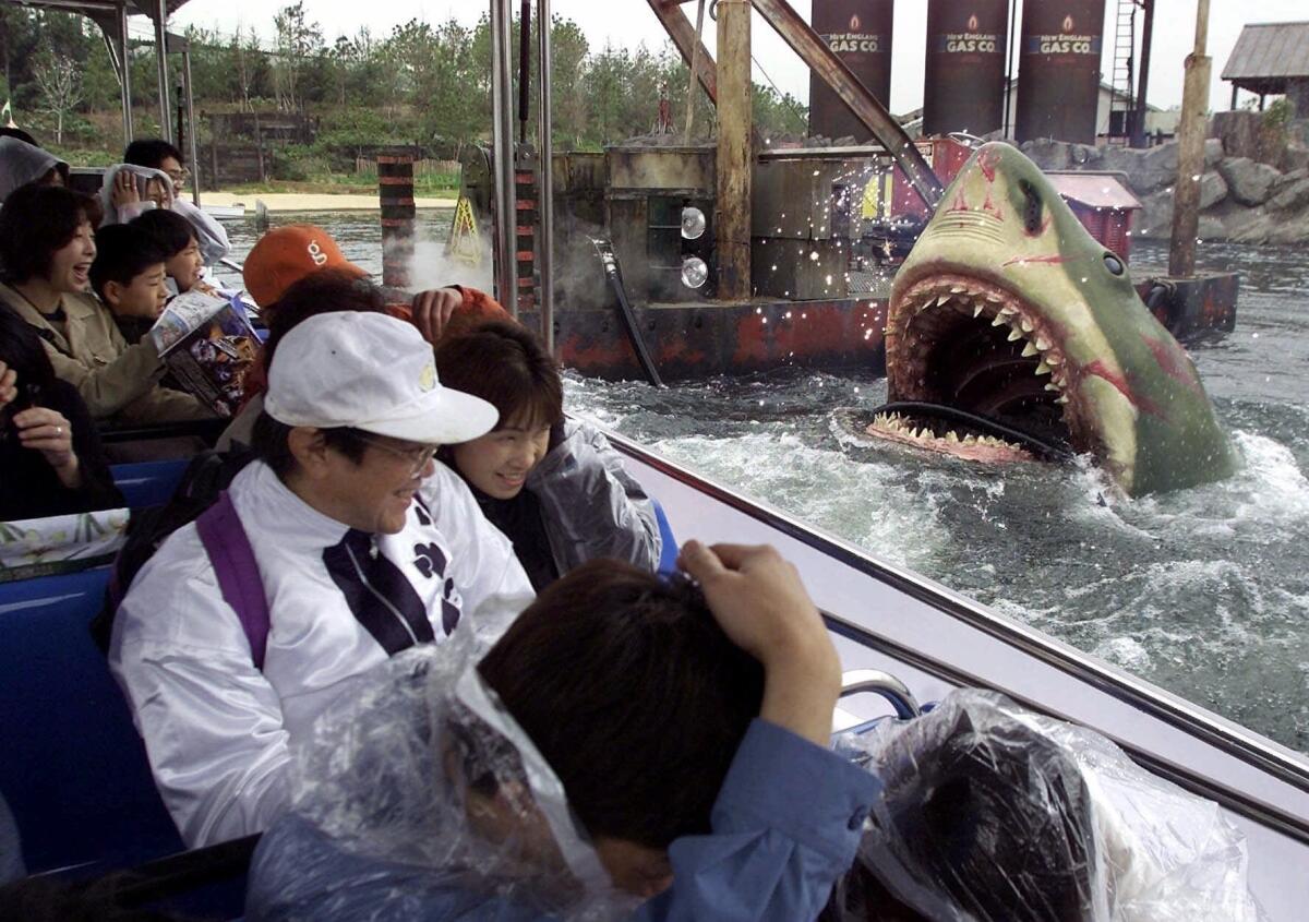 Japanese guests, on a boat, are frightened during a tour of Jaws, one of Universal Studios' attrections, at a press preview of Universal Studios Japan in Osaka, western Japan. The operators of the park plan to open another theme park in Okinawa.