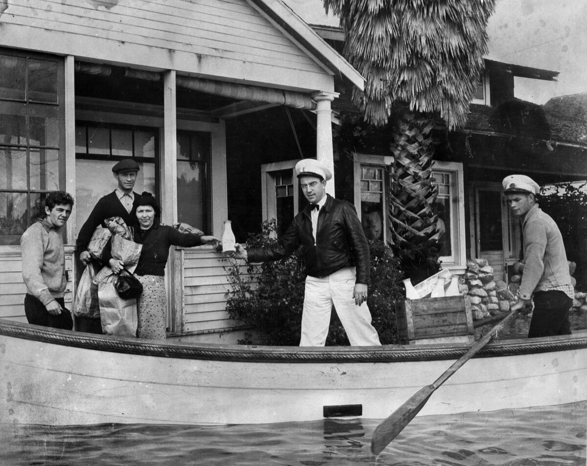 Milkman Ray J. Henville secured himself a boat and boatman and made all deliveries to the doorstep during the 1938 flood.