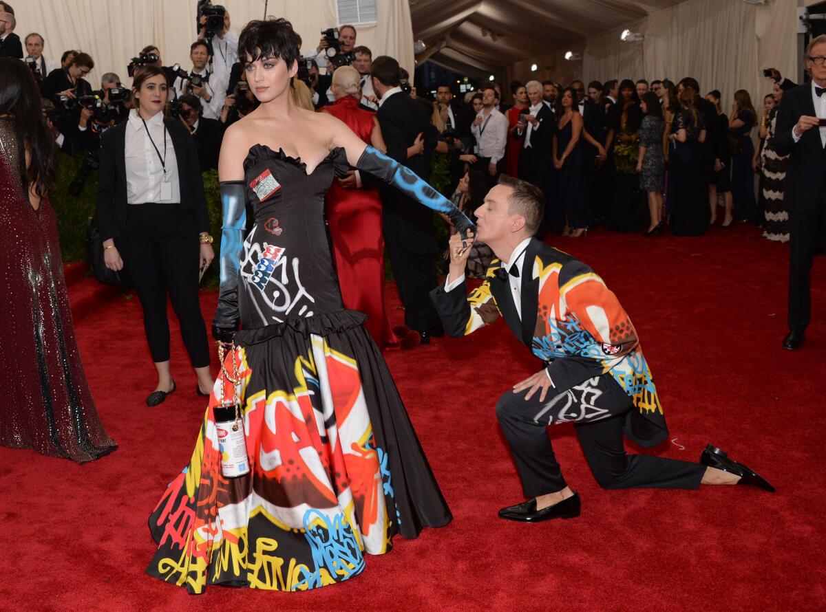 Fashion designer Jeremy Scott kisses Katy Perry's hand as they arive at The Metropolitan Museum of Art's Costume Institute benefit gala celebrating "China: Through the Looking Glass" on Monday.