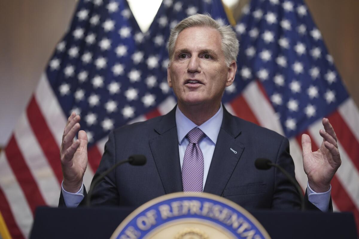 A man speaks at a lectern.