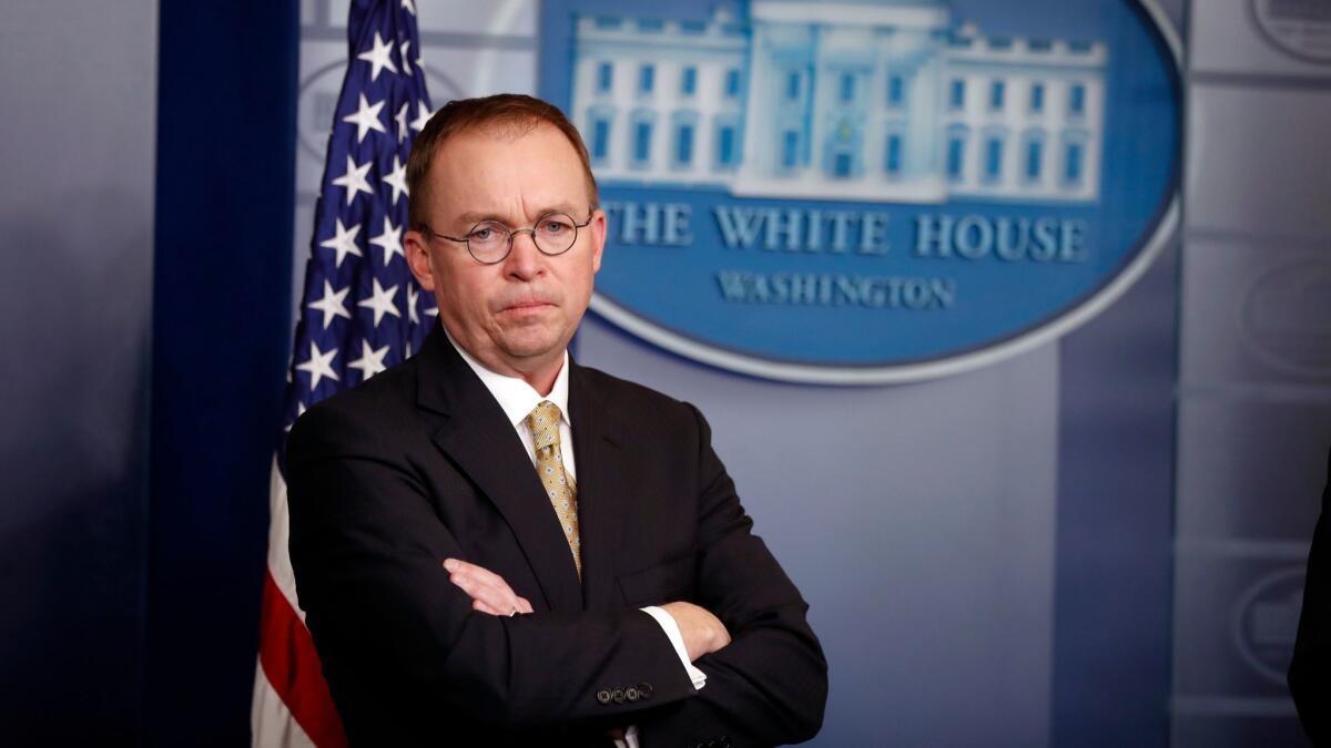 Mick Mulvaney, acting director of the Consumer Financial Protection Bureau, stands during a press briefing at the White House in Washington in January.