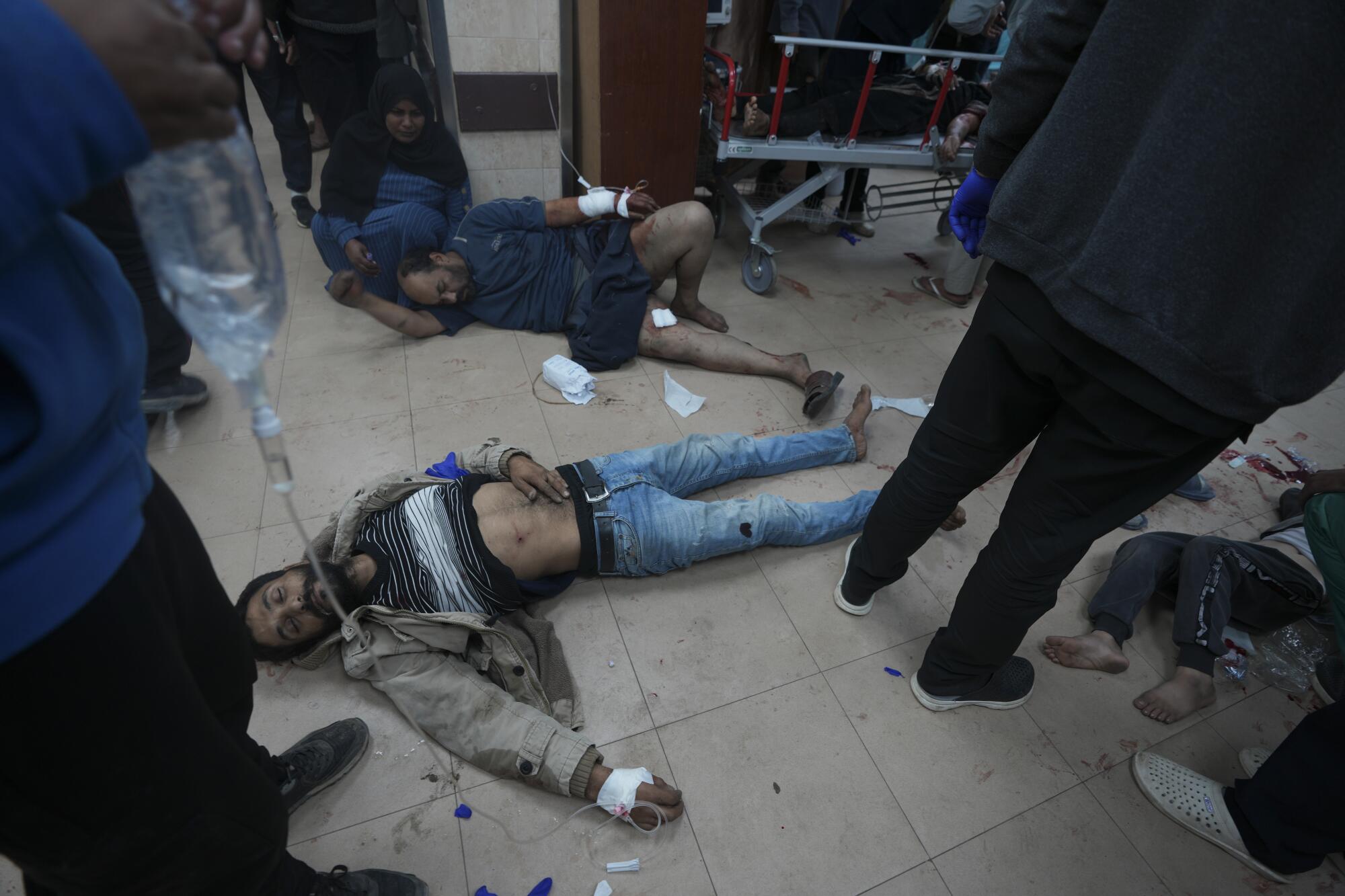 Man lying wounded on hospital floor in Gaza
