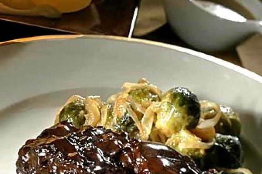 Glazed short ribs with a mustard-Cognac sauce complement the flavors of sweet-and-sour Brussels sprouts.