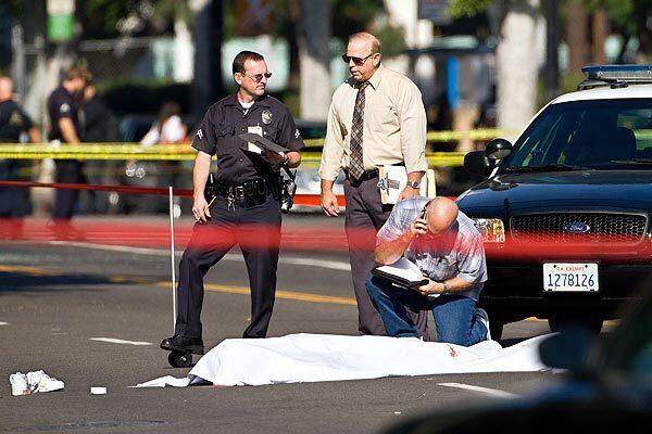 Investigators at the scene in Hollywood, where a suspected gunman who had been randomly firing on motorists was fatally shot by LAPD police.