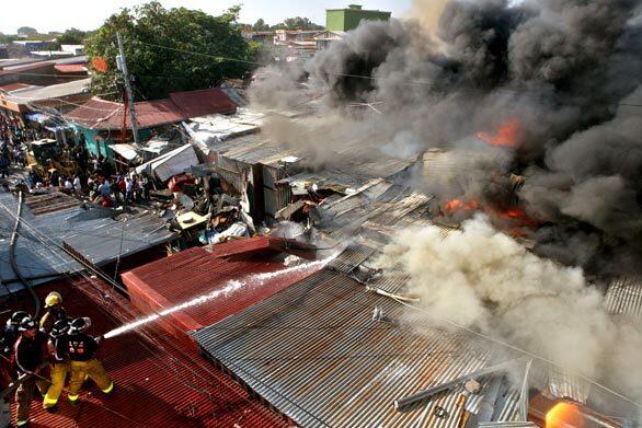 Firefighters work to put out a fire at the Oriental Market in Managua, Nicaragua. No injuries were reported.