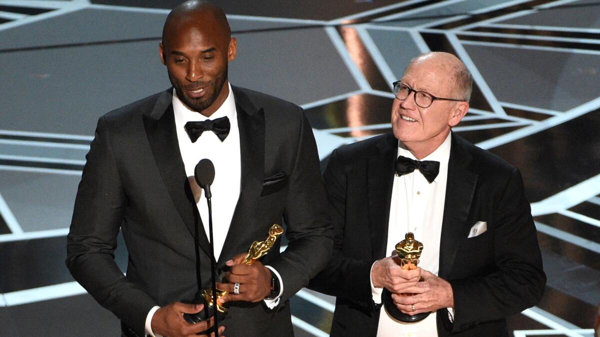 Kobe Bryant, left, and Glen Keane accept the Oscar for animated short.