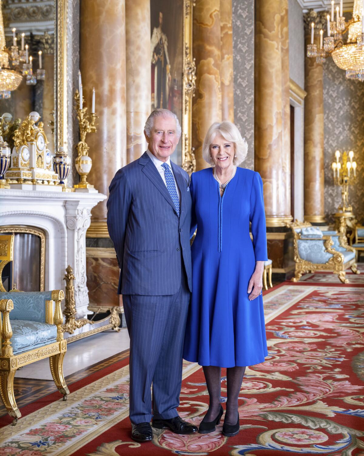 Britain's King Charles III and Queen Consort Camilla pose in the Blue Drawing Room at Buckingham Palace.