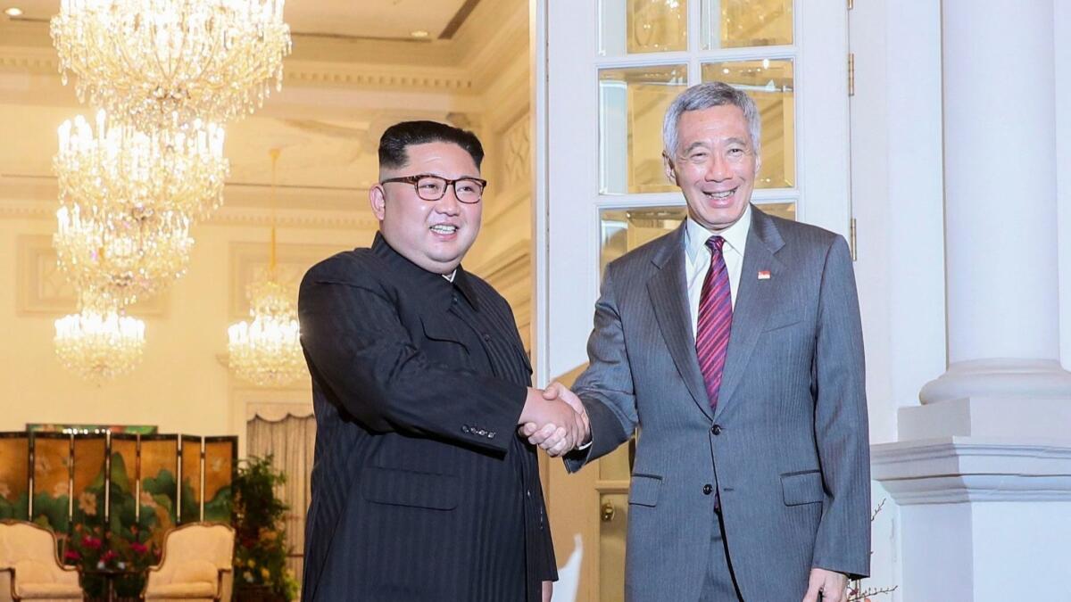 North Korean leader Kim Jong-un, left, and Singapore Prime Minister Lee Hsien Loong meet Sunday at the Istana Presidential Palace in Singapore.