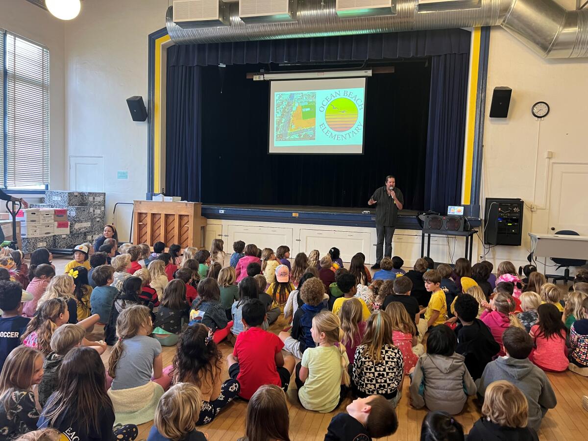 Luminosity founder Mike James speaks at Ocean Beach Elementary School about OB's inaugural Fourth of July drone show.