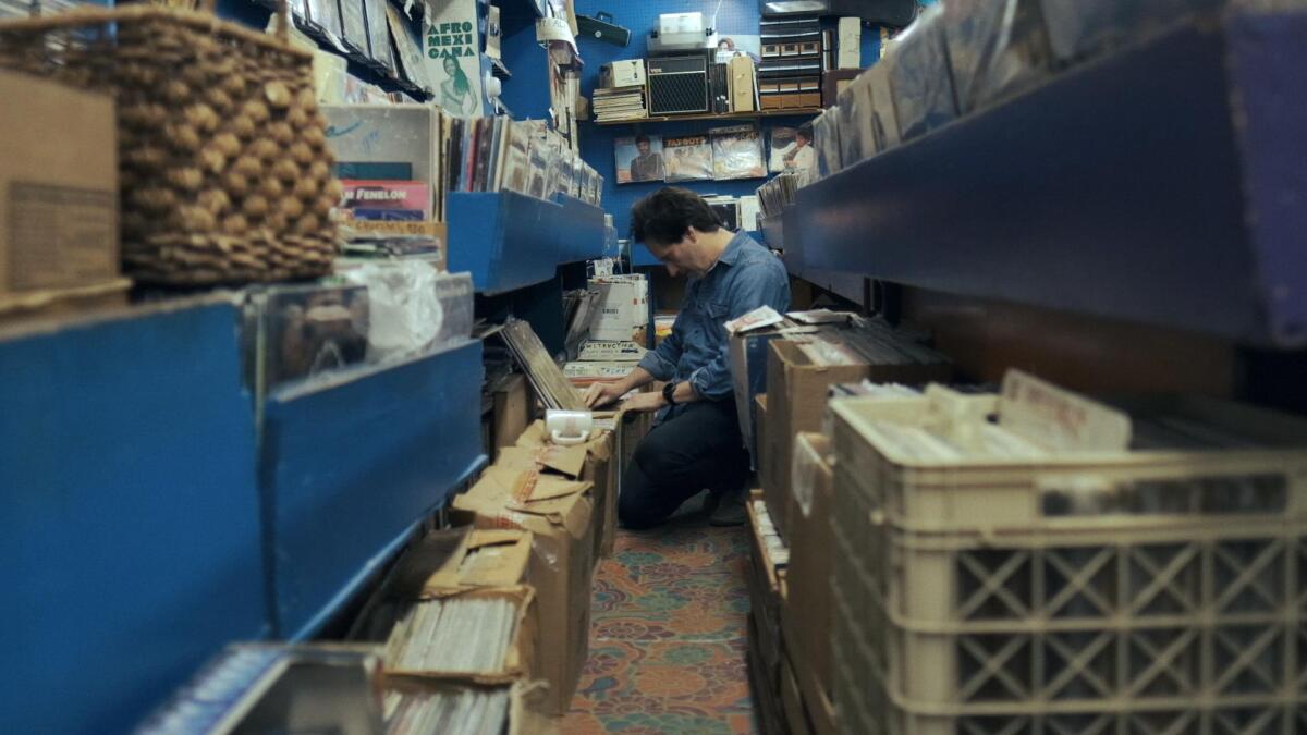 A man looks through used records.