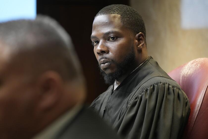 FILE -Oakland County Judge Kwame Rowe looks towards witness during cross examination, July 27, 2023, in Pontiac, Mich. The teenager who killed four students at Michigan’s Oxford High School will learn whether he will spend his life in prison or get a chance for parole in the decades ahead. Judge Rowe will announce his decision Friday, Sept. 29. (AP Photo/Carlos Osorio, File)