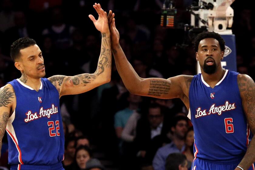Clippers forward Matt Barnes, left, and center DeAndre Jordan, who combined for 25 points and 16 rebounds before sitting out the fourth quarter, celebrate after a foul is called against the Knicks on Wednesday night.