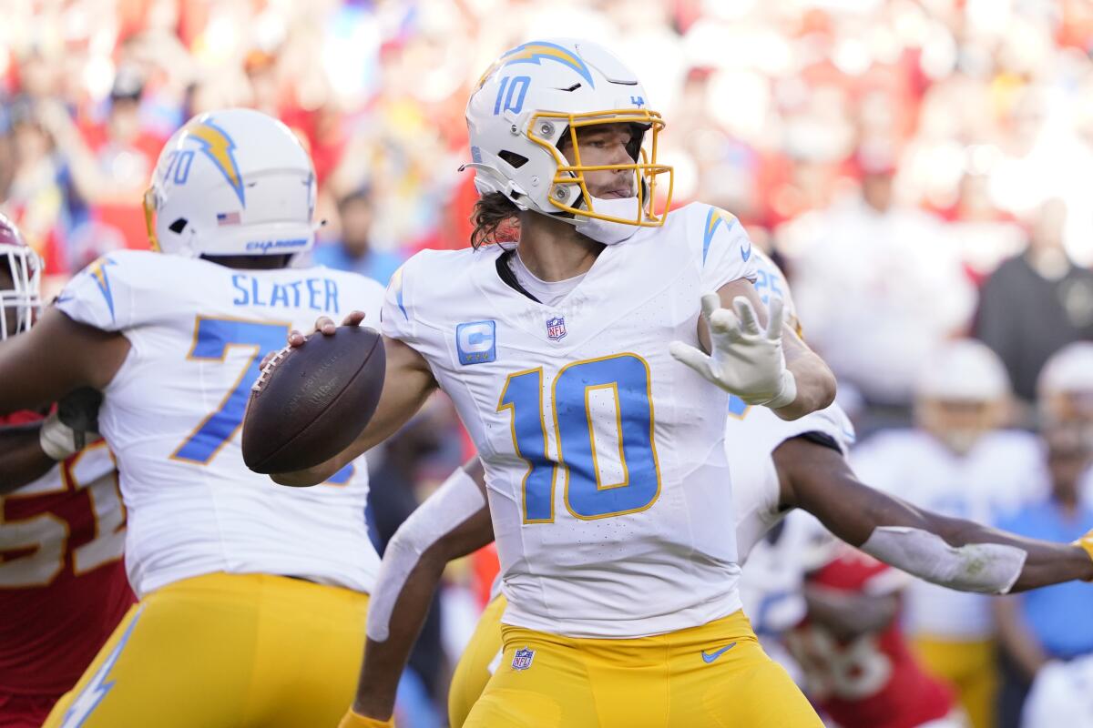 Chargers quarterback Justin Herbert (10) readies to pass against the Chiefs.
